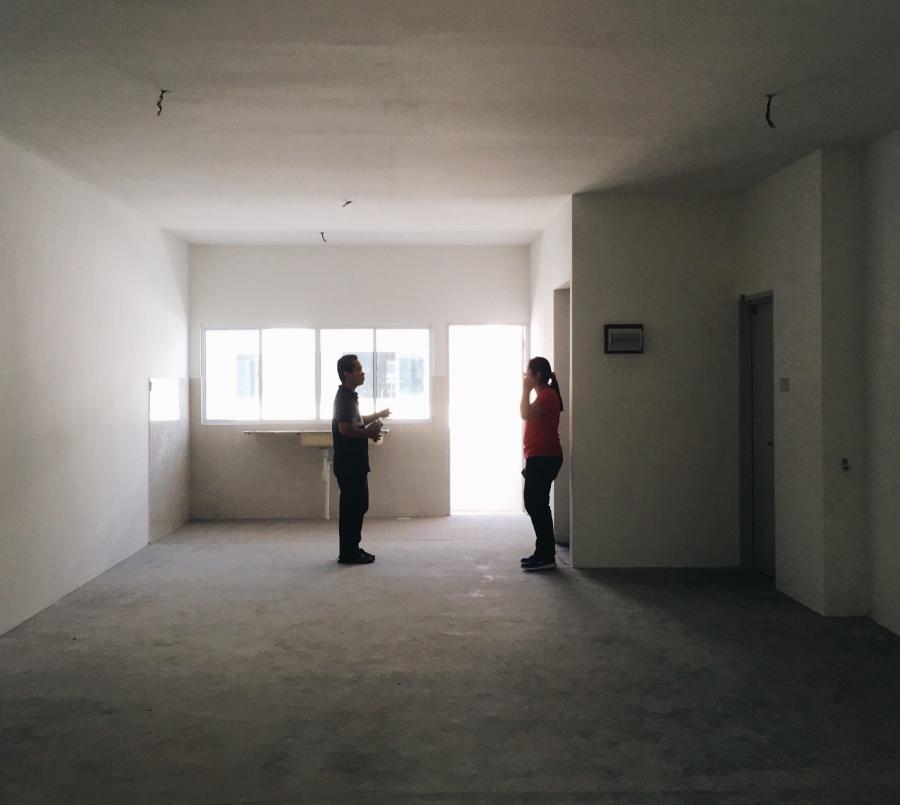 Woman and man in an empty apartment
