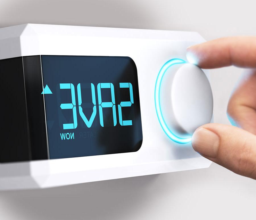 fingers adjusting programmable thermostat